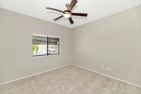 Chandler apartment for rent - a bedroom with a ceiling fan and a window