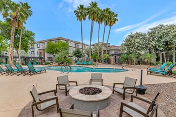 Our apartments have a resort style pool with chairs and a fire pit