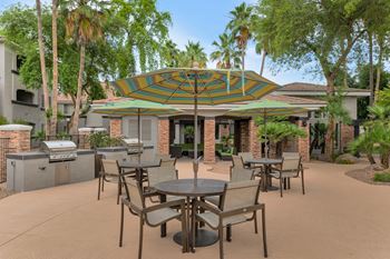 An outdoor patio area with tables and umbrellas