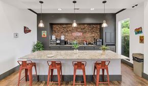 Chandler apartment for rent - A kitchen with a bar area and four stools at Montage at Pecos Ranch Apartments, Chandler, AZ