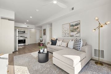Phoenix apartment for rent - A modern living room with a white couch and a coffee table.