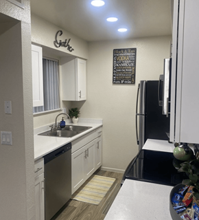 Mesa apartment for rent - A kitchen with a white counter top and a black fridge.