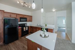 Prescott Valley apartment for rent - a kitchen with a white counter top and a black refrigerator