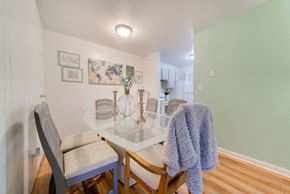 Racine apartment for rent - A dining room with a white table and chairs.