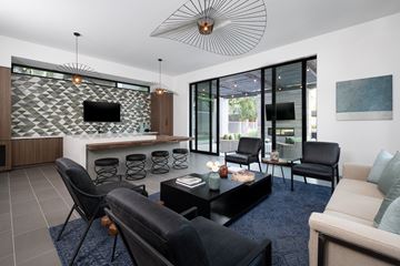 Glendale apartment for rent - A modern living room with black leather chairs and a patterned wall.