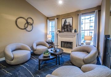 Dallas apartment for rent - A living room with a fireplace and a painting of two horses.