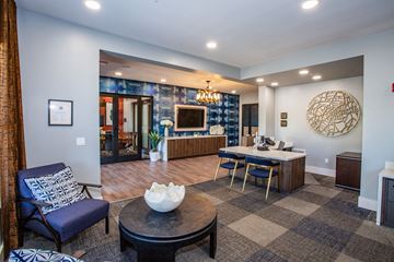 Phoenix apartment for rent - A living room with a blue chair and a coffee table.