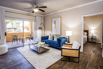 Glendale apartment for rent - A living room with a blue couch and a fan on the ceiling.