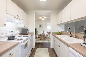 Goleta apartment for rent - 1-Bedroom Apartments in Goleta, CA - Pacific Oaks - Kitchen With Electric Stove, Sink, and Countertops, Upper And Lower Cabinets.