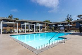 Santa Barbara apartment for rent - a swimming pool with chairs and umbrellas around it