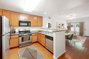 Ventura apartment for rent - Ventura, CA Apartments - Ralston Courtyards - Kitchen With Plank Flooring, Stainless-Steel Appliances, And Custom Wood Cabinets.