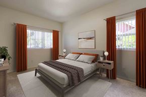 Santa Barbara apartment for rent - Dog-Friendly Apartments in Goleta, CA - Sumida Gardens - Bedroom with Plush Carpeting, Large Bed, Nightstands with Lamps, Wall Art, and Windows.