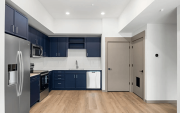 Hailey condo for rent - A modern kitchen with dark blue cabinets and a stainless steel refrigerator.