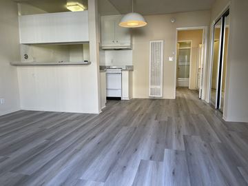 Los Angeles apartment for rent - an empty living room with wood flooring and a kitchen