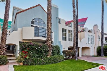 West Hollywood apartment for rent - the exterior of a house with palm trees and a sidewalk