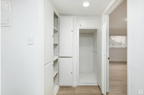 Los Angeles apartment for rent - a bedroom with a white closet and a hallway with a door open