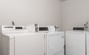 Los Angeles apartment for rent - A row of white washing machines in a laundry room.