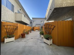 Los Angeles apartment for rent - A courtyard with orange fences and potted plants at 3615 Watseka Ave, Los Angeles, CA, 90034