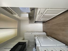 Los Angeles apartment for rent - A row of white washing machines in a laundry room.