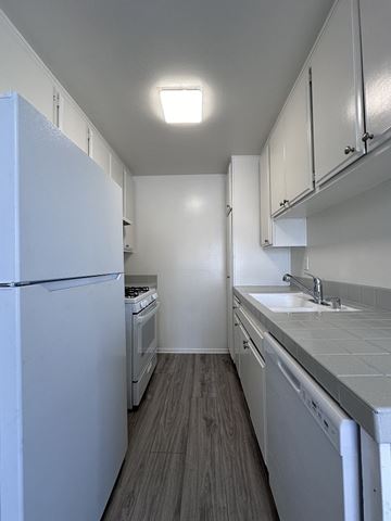 Los Angeles apartment for rent - A kitchen with white appliances and cabinets.
