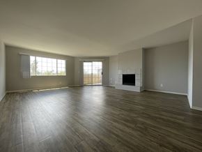 Los Angeles apartment for rent - A spacious living room with a fireplace and hardwood floors at Lido Apartments, California
