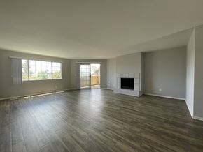 Los Angeles apartment for rent - A spacious room with a fireplace and wood flooring at Lido Apartments, Los Angeles, CA