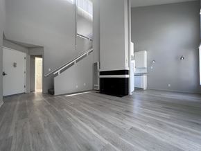 Los Angeles apartment for rent - A spacious room with a staircase and a fireplace.