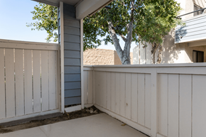 Anaheim apartment for rent - A white wooden deck with a tree in the background at Lido Apartments - 101-197 N Ridgeway, Anaheim, CA
