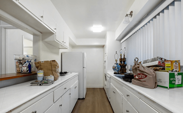 Los Angeles apartment for rent - A kitchen with white cabinets and a white fridge.