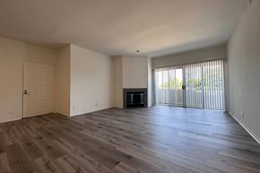 Los Angeles apartment for rent - A spacious room with wooden flooring and a television in the corner. at Property Name Apartments, Los Angeles California
