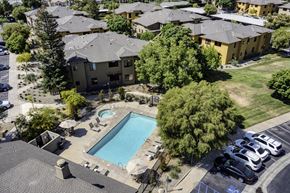 Bakersfield apartment for rent - an aerial view of an apartment complex with a swimming pool and parking lot  at Polo Villas, California, 93312