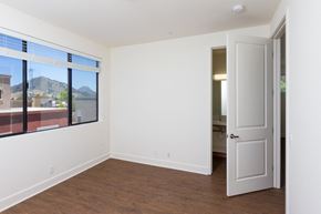 San Luis Obispo apartment for rent - a bedroom with a large window and a door that leads to a bathroom at Roundhouse Place, California