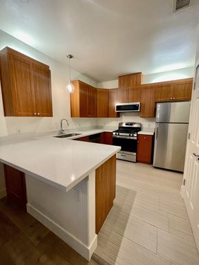 Bakersfield apartment for rent - a kitchen with white countertops and wooden cabinets  at Polo Villas, California