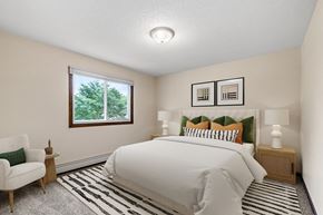 St. Paul apartment for rent - the master bedroom is spacious and has a large bed and a window