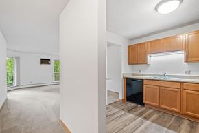 Plymouth apartment for rent - a kitchen and living room with wood flooring and white walls