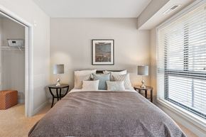 Bloomington apartment for rent - a bedroom with a large bed and two windows