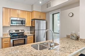 Bloomington apartment for rent - a kitchen with granite countertops and stainless steel appliances
