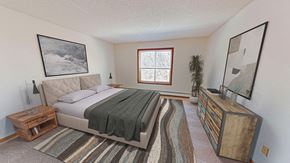 Eagan apartment for rent - a bedroom with a bed and a dresser and a window
