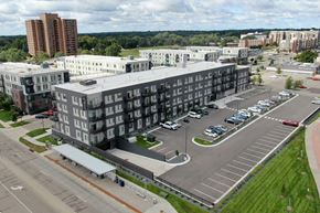 Bloomington apartment for rent - A parking lot in front of a large building.