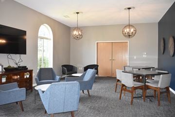 Woodbury townhouse for rent - A living room with a grey carpet and a wooden dining table.