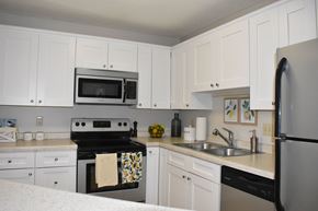 St. Paul apartment for rent - A kitchen with white cabinets and appliances.