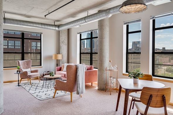 Minneapolis apartment for rent - Living room with large windows and a variety of seating