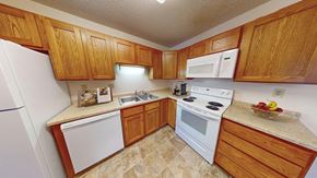 Eagan apartment for rent - a kitchen with white appliances and wooden cabinets
