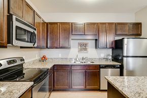 New Brighton apartment for rent - Community kitchen with dark wooden cabinets and silver appliances