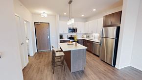 Robbinsdale apartment for rent - a kitchen with stainless steel appliances and a white counter top