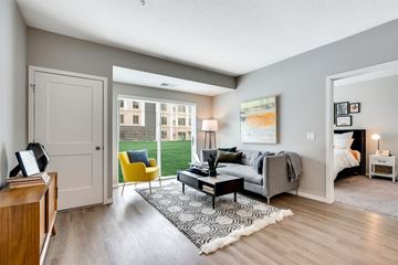 Bloomington apartment for rent - a living room with a couch and a chair and a door to a bedroom