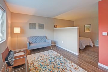 St. Paul apartment for rent - a living room with a couch and a chair and a bedroom with a bed