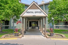 Eagan apartment for rent - a rentals office with an american flag on the side of the road
