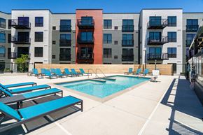Robbinsdale apartment for rent - Community outdoor pool surrounded by blue pool chairs