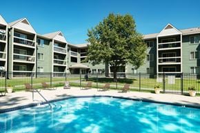Eagan apartment for rent - A swimming pool in front of apartment buildings.
